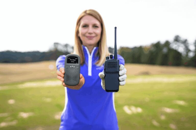 Woman on the golf course holding a two way radio and Relay