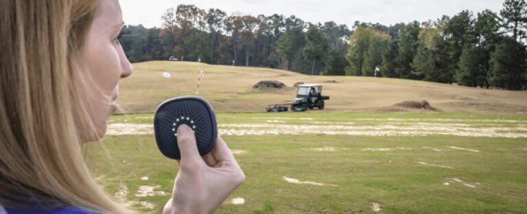 A golf course employee talking into a Relay.
