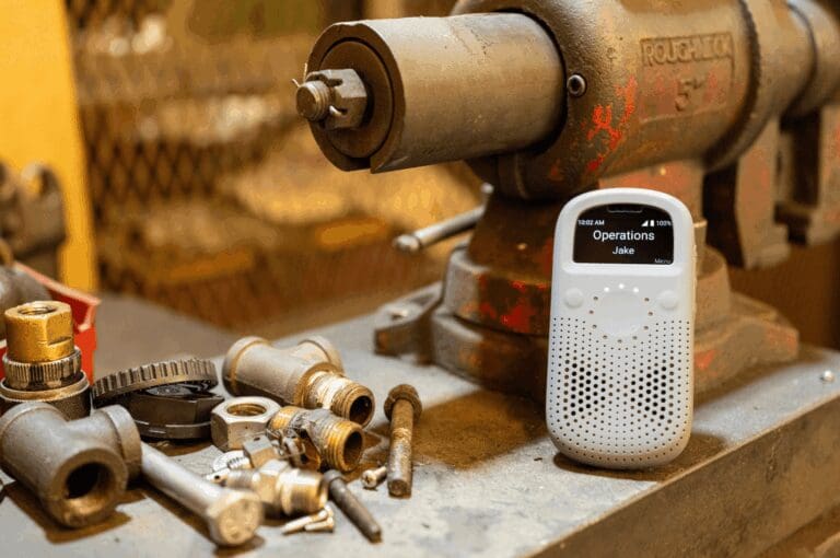 Smart walkie talkie RelayX sitting next to industrial tools