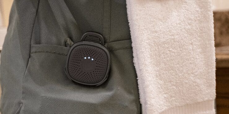 An employee folding towels, wearing Relay+.