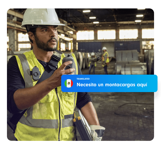 An Industrial worker hearing a English message translated message to Spanish.