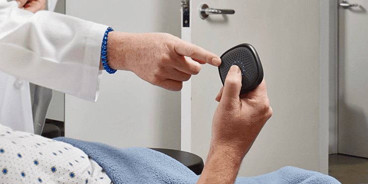 Doctor Showing Patient How to Use Relay Device