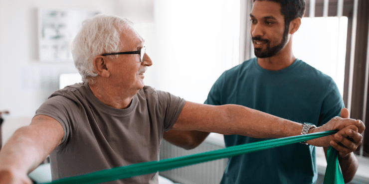 A resident doing on-site physical therapy with a staff assistants
