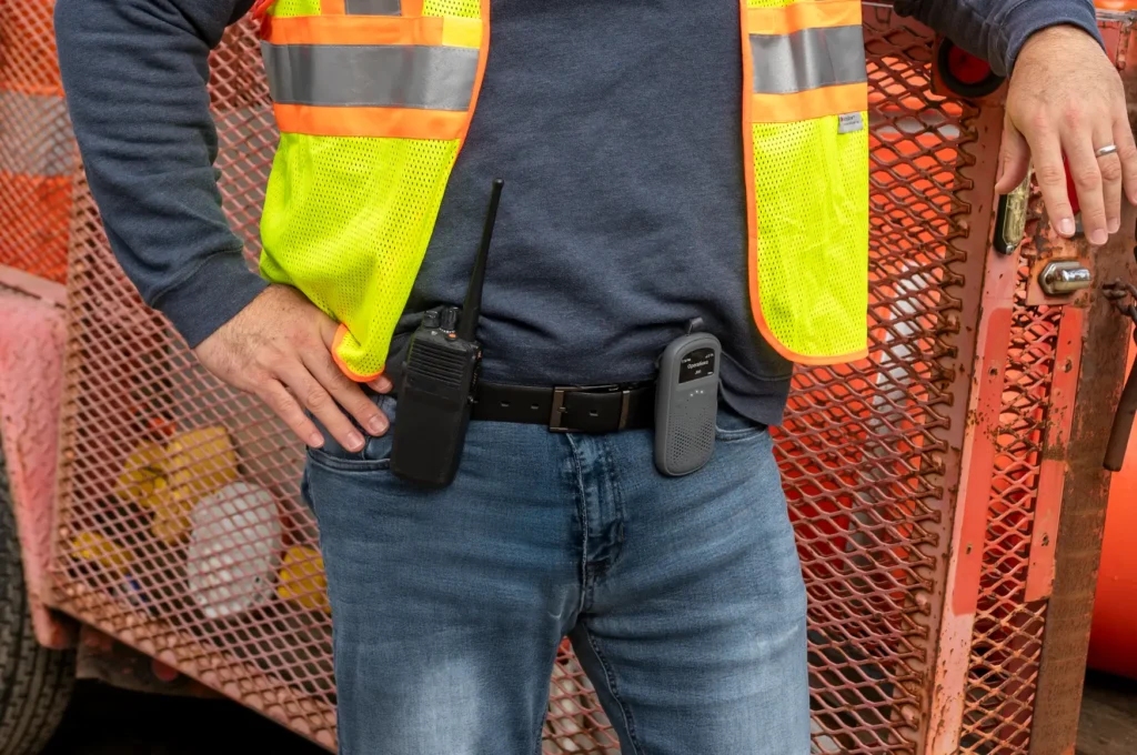 Industrial worker with Relay radio and traditional walkie talkie on his belt