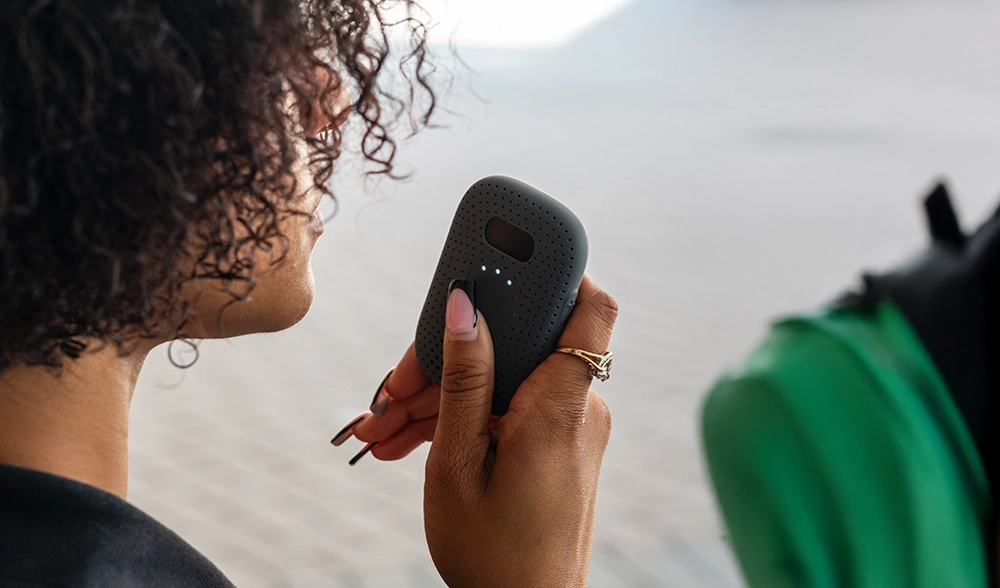 School staff member uses a Relay device for panic alert while supervising students outdoors.