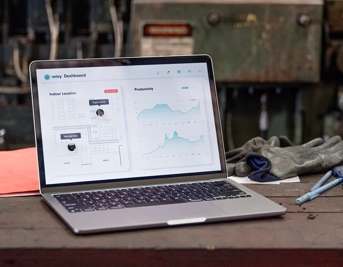 Relay dashboard on a laptop showing indoor location tracking and productivity metrics in a manufacturing environment.
