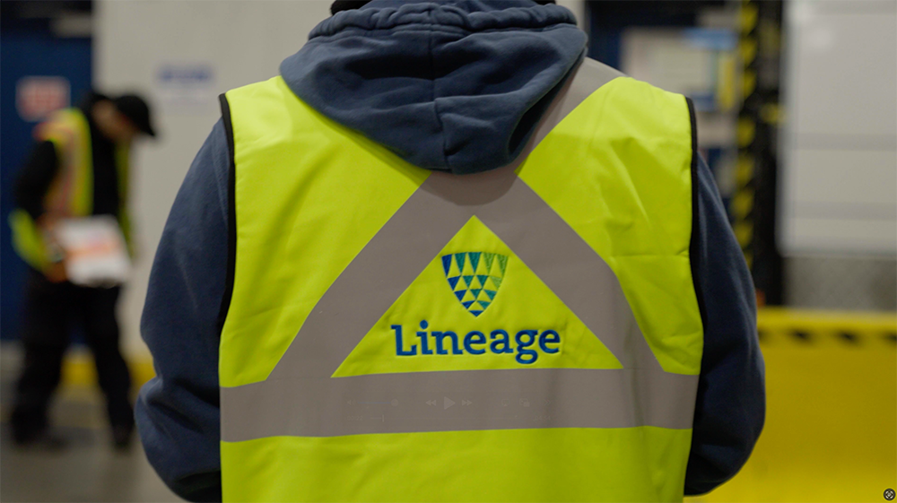 Man wearing yellow Lineage Logistics vest
