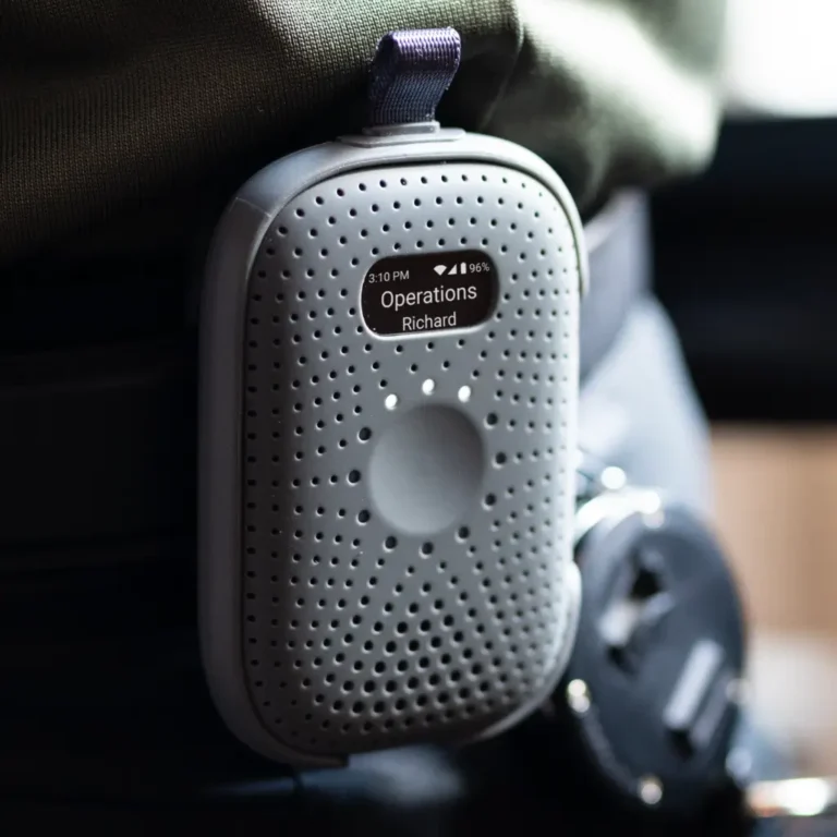 RelayM clipped to user’s belt showing display screen